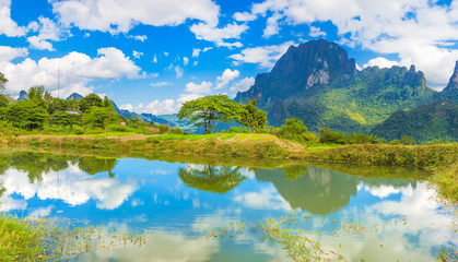 Naklejka premium Beautiful landscape, pond on the foreground. Laos.