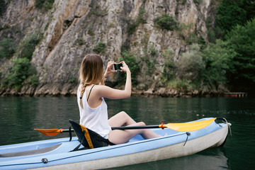 Woman kayaking and taking photos