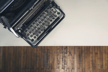 Vintage old typewriter on a white desk in an old room