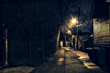 Dark, gritty and wet Chicago alley at night after rain.