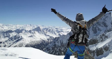 Climber mountaineer man reaching snowy mount top success in sunny day.Mountaineering ski activity. Skier people winter snow sport in alpine mountain outdoor.Back view.Slow motion 60p 4k video - Powered by Adobe