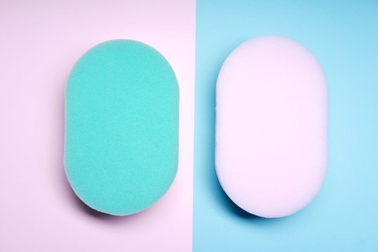 Pink and blue sponges on pink and blue background.