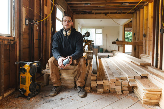 Carpenter man taking break on jobsite - drinking water