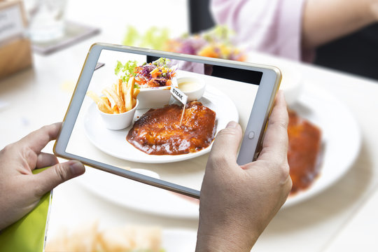 Using smartphone to take food photo.