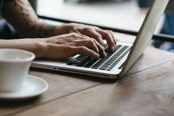 Man working on laptop at the cafeteria
