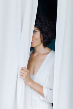 Female posing near curtains