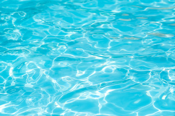 Fototapeta na wymiar Blue and bright water in swimming pool with sun reflection, Motion of ripple water and gentle wave in pool