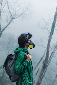 Female in mask walking on volcano