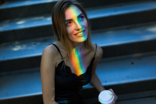 Beautiful woman with a colorful ray of light