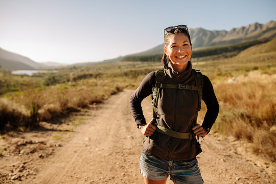 Woman hiking through mountain trail on a sunny day – Jacob Lund