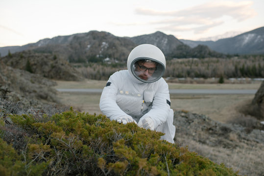 Cosmonaut taking grass samples