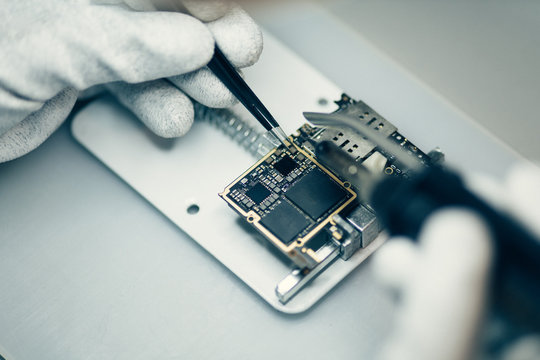 Man repairing smartphone.