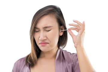 Woman is cleaning ear with a cotton swab