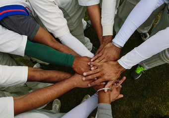 A group of anonymous people placing their hands together