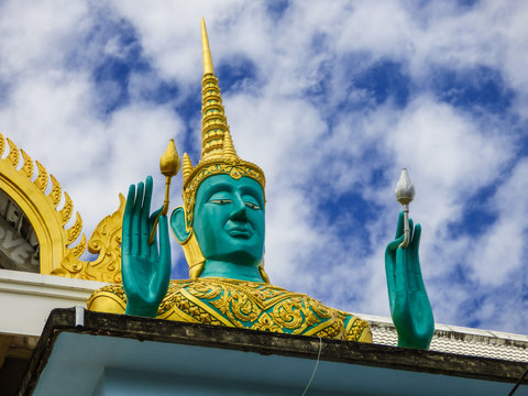 Close up of green god statue at Buddhist temple Wat Kao Iti Sukato in Hua Hin, Thailand
