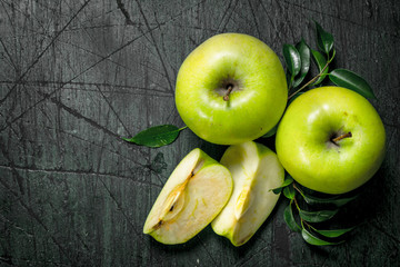Green apples with leaves.