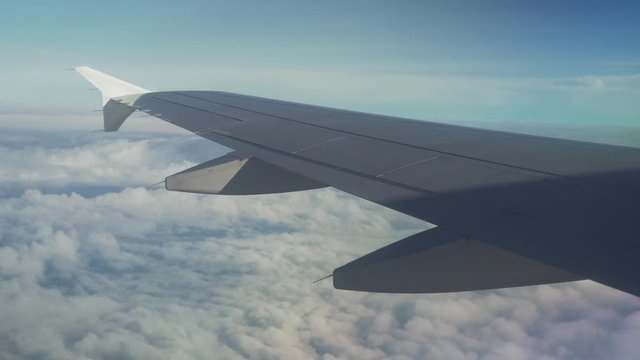 View from an airplane on wing of an airplane and cumulus clouds over the sea stock footage video