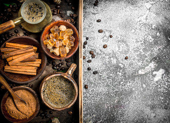 Coffee background. Welded coffee in a Turkish with sugar, cinnamon and coffee beans.