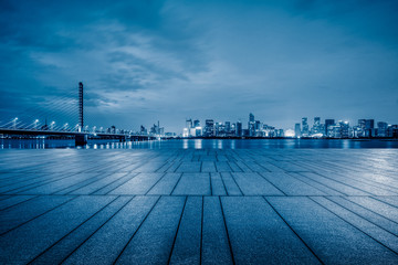 night view of empty brick floor front of modern building