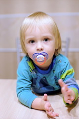 Fototapeta premium cute baby at the table