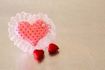 Fototapeta premium big laced textile heart with two small hearts on glitter silver background