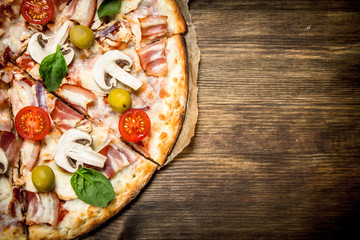 Fresh pizza. On wooden table.