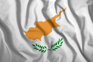 The Cyprus flag flies in the wind. Colorful national flag of the Cyprus. Patriotism, patriotic symbol.