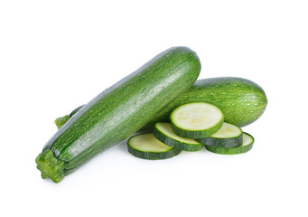 whole and sliced fresh zucchini on white background