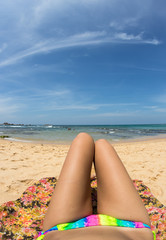 Beautiful woman in bikini sunbathing at the seaside