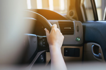 Hands of female driver on steering wheel,Woman driving a car