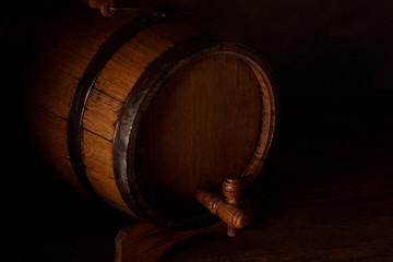 a small wooden wine bar, barrel on the legs and a wooden crane on a wooden background