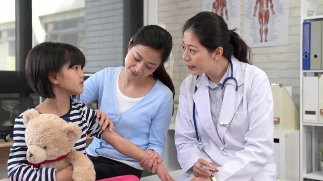 asian doctor help little patient to injection
