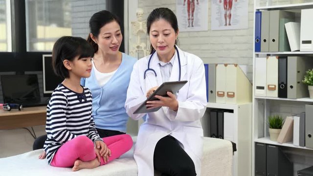 Asian female doctor showing digital tablet