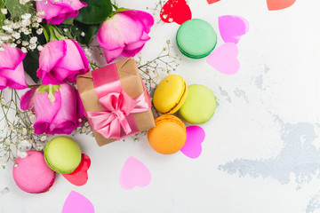 Valentines day background with roses, macaroons and decorative hearts