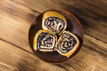 Poppy seed rolls on wooden table