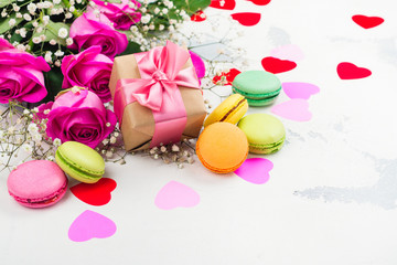 Valentines day background with roses, macaroons and decorative hearts