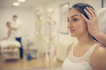 Obraz premium Physical therapy. Young woman at doctor treatment.