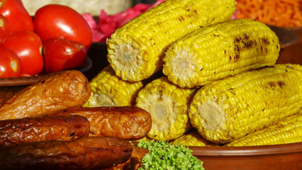 Grilled sausages with baked corn on the home