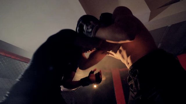 A low view on two fighters grappling each other.