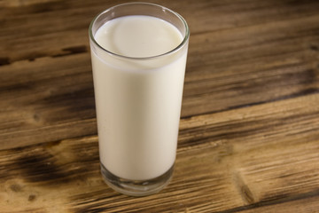 Glass of milk on wooden table