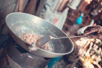 Coconut cooking in a pan, San Jose, Philippines