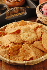 A pile of heart  chrysanthemum shape biscuits on wooden table