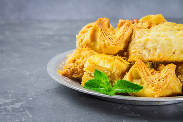 baklava turkish traditional delight on a dark wood background. toning.