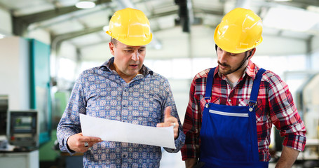 Engineer Teaching Apprentices To Use Computerized cnc metal processing machines