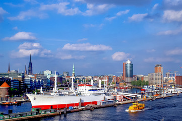 Fototapeta na wymiar Panorama on the Elbe. Hanseatic Portcity of Hamburg by good travel weather.