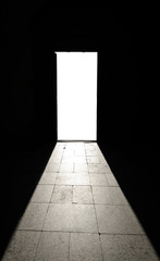 Entrance with black walls on isolated white door. Template or mock up.  Corridor with black wall, stone tile on the floor, white isolated blank door 