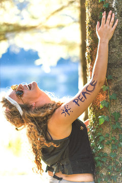 Pretty free hippie girl laughing. Peace. Body painting. - Vintage effect photo