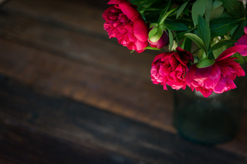 Beautiful  bunch of peony on a wooden table. Spring or summer lovely bouquet. Card, text place, copy space. Wallpaper, trendy color.