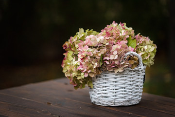 Stylish bouquet, beauty bunch of pink flowers , summer lovely bouquet on a wooden table.  Card, text  place, copy space. Wallpaper, trendy color.
