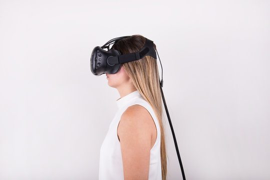 attractive, blonde, young woman wearing virtual reality headset